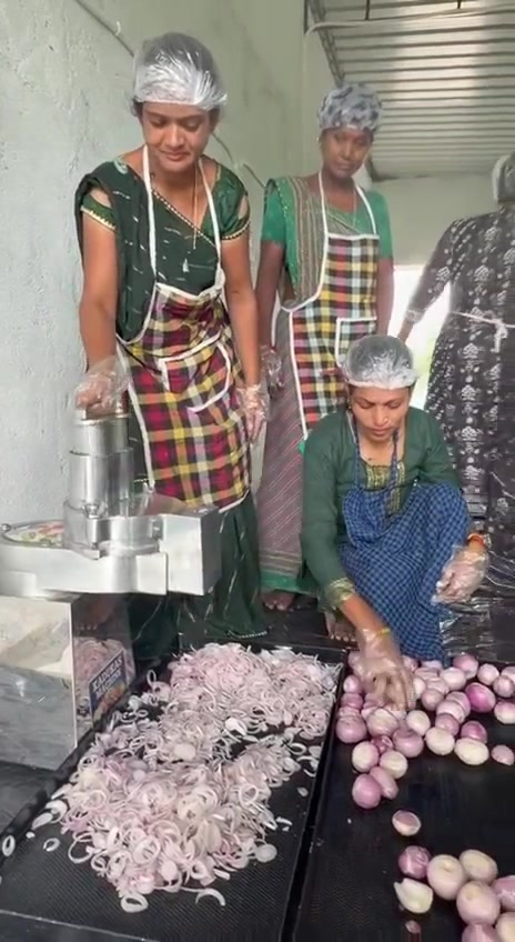Women processing produce at the village unit