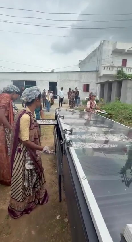 A woman operating food-processing equipment